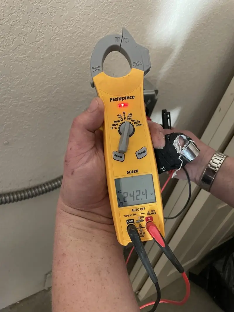 Voltage testing with clamp meter during Ceiling Fan Installation in Monona